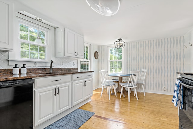 kitchen featuring light wood-type flooring, black appliances, white cabinets, sink, and pendant lighting