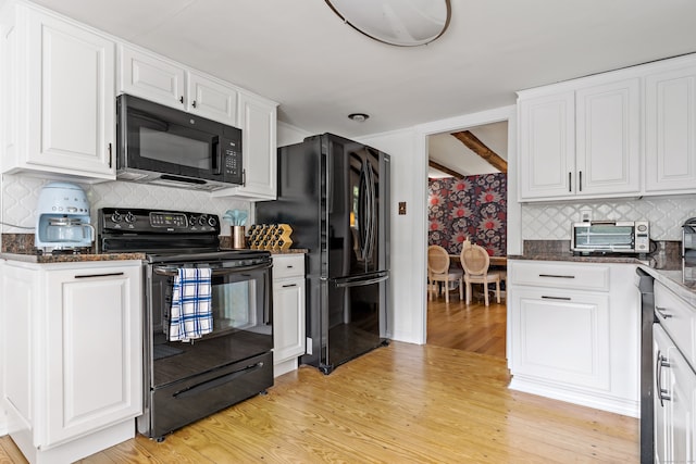 kitchen with black appliances, decorative backsplash, white cabinets, and light hardwood / wood-style flooring