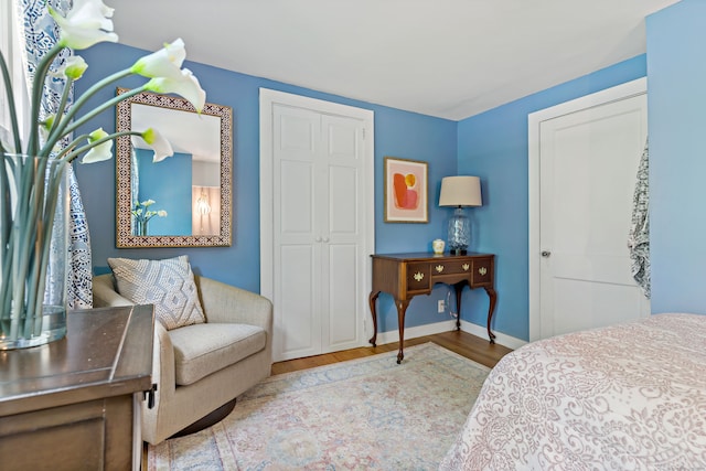 bedroom with light wood-type flooring and a closet