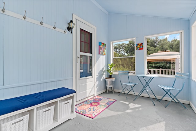 unfurnished sunroom featuring vaulted ceiling