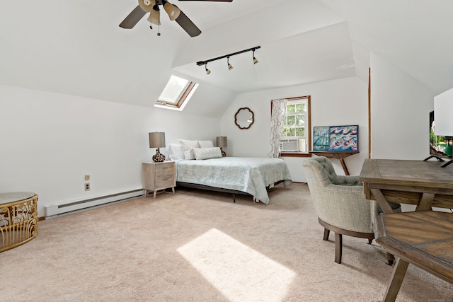 carpeted bedroom featuring ceiling fan, cooling unit, rail lighting, lofted ceiling with skylight, and a baseboard radiator