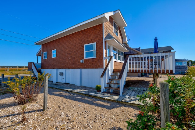 view of home's exterior with a wooden deck