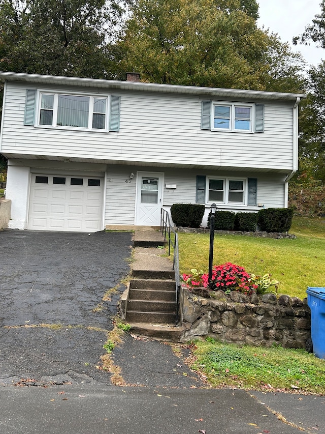 view of front of house featuring a front yard and a garage