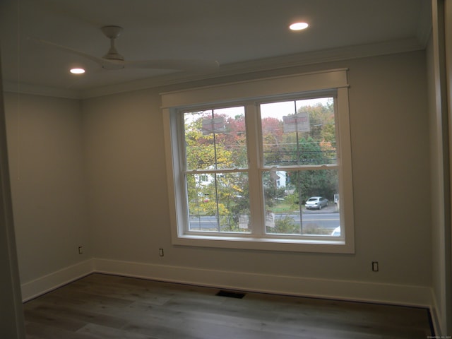 unfurnished room with dark wood-type flooring and ornamental molding