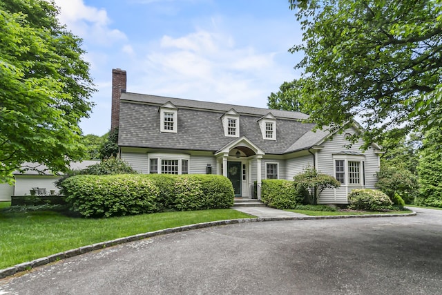 91 Open Gate Ln, Fairfield, CT 06890 - dutch colonial featuring a chimney, a shingled roof, and a front yard