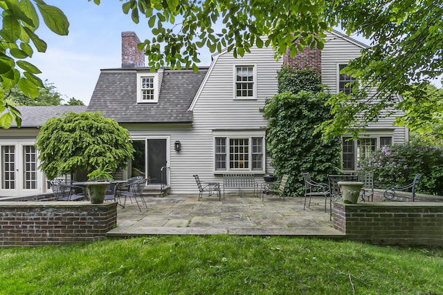 91 Open Gate Ln, Fairfield, CT 06890 - back of house with a yard, a chimney, a patio, and roof with shingles