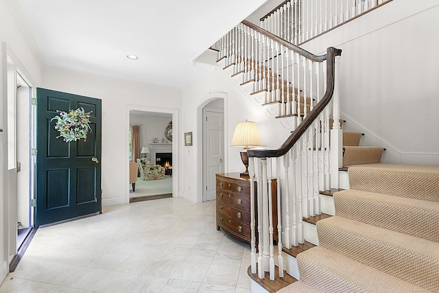 91 Open Gate Ln, Fairfield, CT 06890 - entryway featuring stairway, baseboards, a lit fireplace, recessed lighting, and crown molding