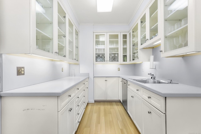 91 Open Gate Ln, Fairfield, CT 06890 - kitchen with a sink, dishwasher, light wood-style flooring, light countertops, and white cabinetry