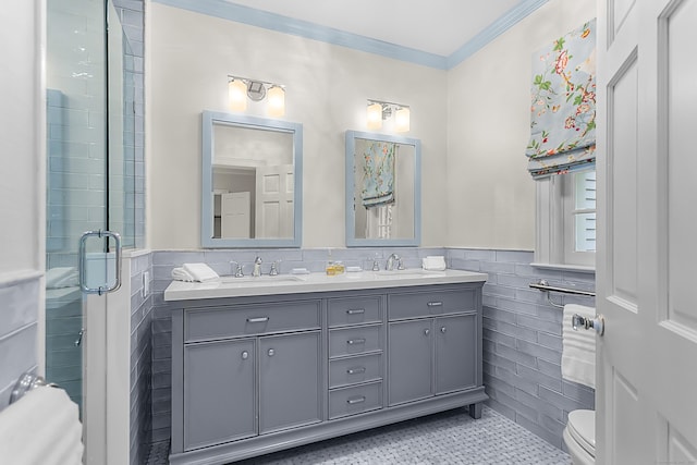 91 Open Gate Ln, Fairfield, CT 06890 - bathroom featuring tile walls, wainscoting, double vanity, toilet, and crown molding