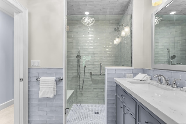 91 Open Gate Ln, Fairfield, CT 06890 - bathroom featuring vanity, tile walls, a stall shower, and a wainscoted wall