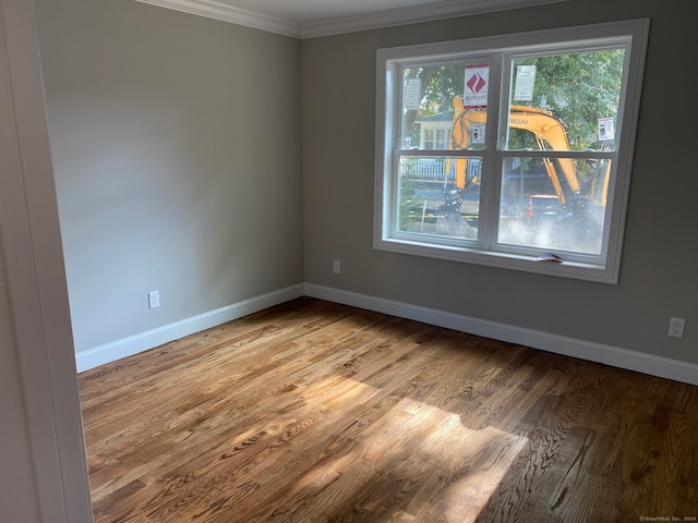 empty room with light wood-type flooring and ornamental molding