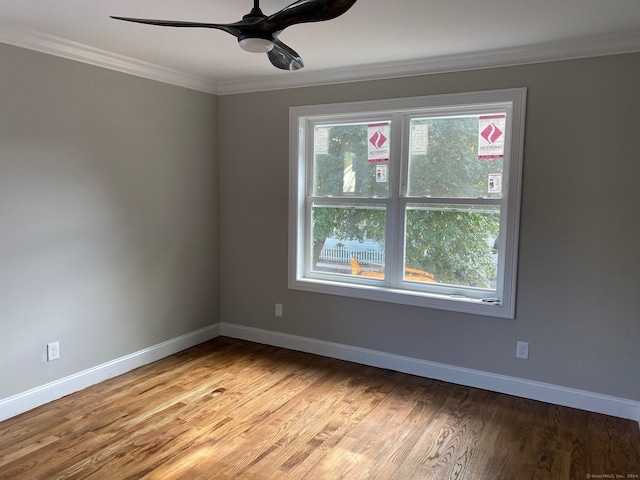 spare room with ornamental molding, ceiling fan, and light hardwood / wood-style floors