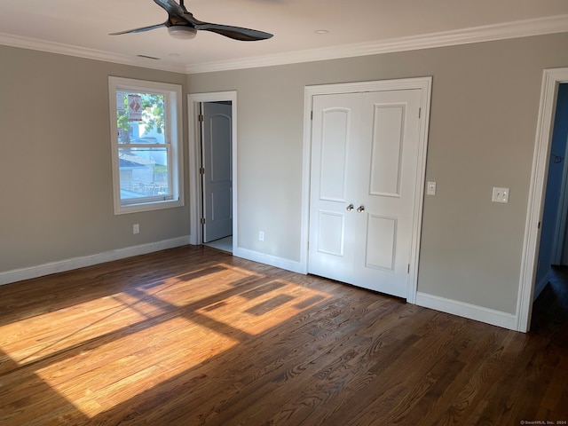 unfurnished bedroom with ceiling fan, dark hardwood / wood-style floors, and crown molding