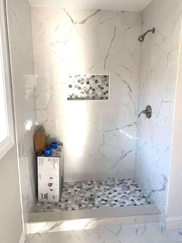 bathroom with tiled shower