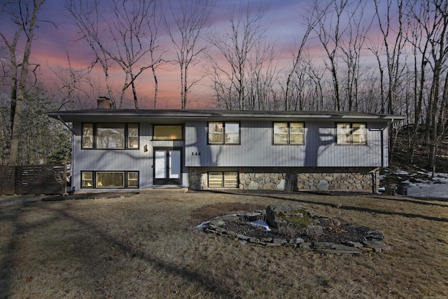 raised ranch featuring a chimney