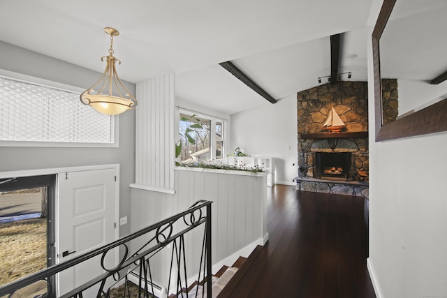 hallway with baseboards, lofted ceiling with beams, dark wood-style flooring, a baseboard heating unit, and an upstairs landing