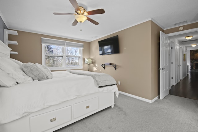 bedroom with visible vents, a ceiling fan, crown molding, baseboards, and light colored carpet