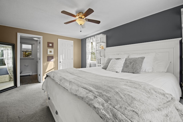 carpeted bedroom featuring a baseboard heating unit and a ceiling fan