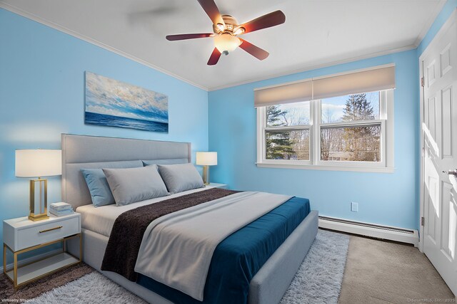 carpeted bedroom featuring a baseboard heating unit, ceiling fan, and ornamental molding