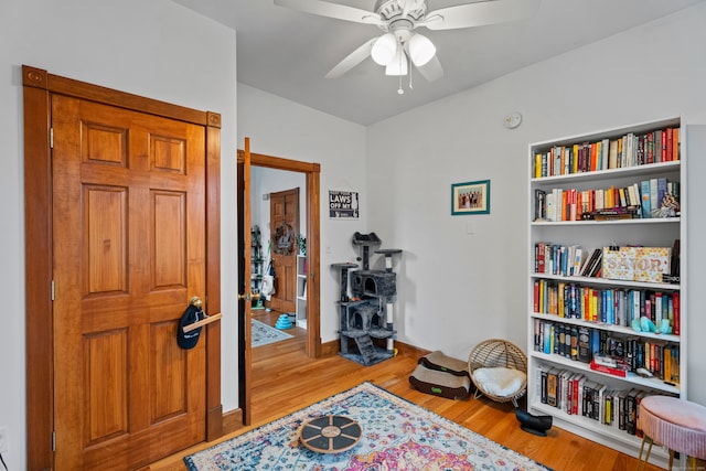 sitting room featuring light wood-type flooring and ceiling fan