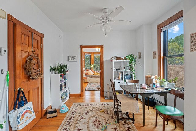 dining room featuring ceiling fan, light wood-type flooring, and plenty of natural light