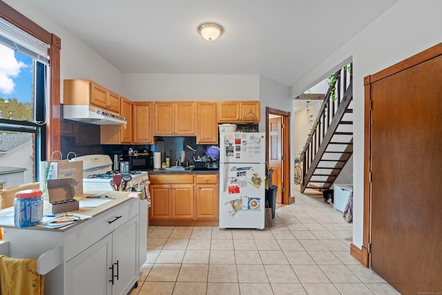 kitchen featuring white appliances, backsplash, and light tile patterned floors