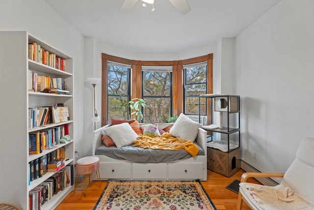 bedroom with ceiling fan and light hardwood / wood-style floors