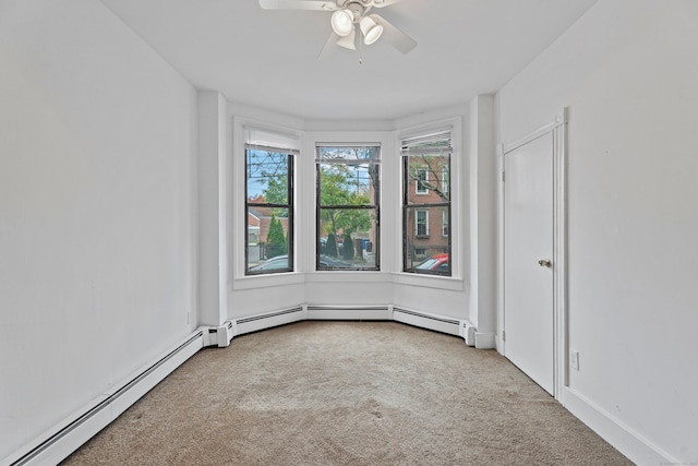 unfurnished room with carpet flooring, a baseboard heating unit, and ceiling fan