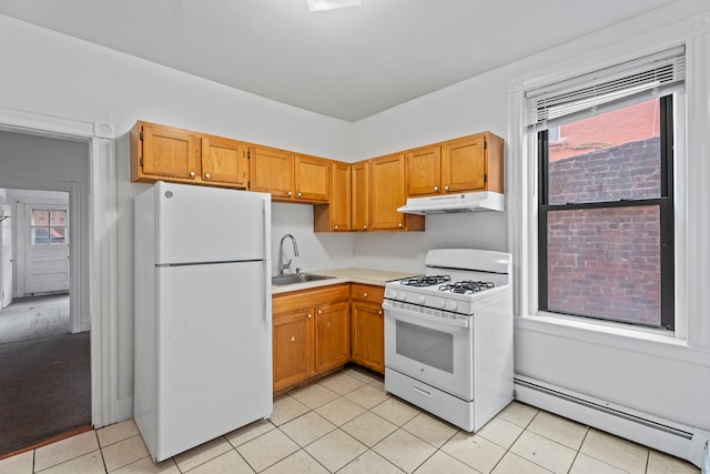 kitchen featuring white appliances, sink, light tile patterned floors, and baseboard heating