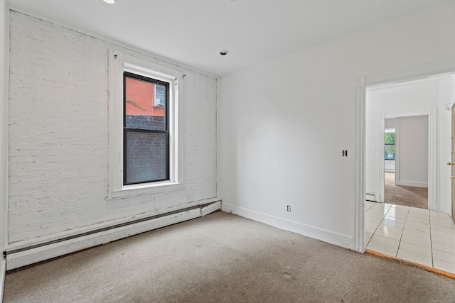 spare room featuring baseboard heating, plenty of natural light, and carpet flooring