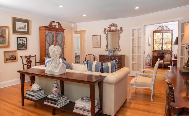 living room featuring light hardwood / wood-style flooring and crown molding