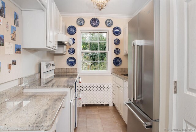 kitchen with light tile patterned floors, ornamental molding, high quality fridge, white cabinetry, and white range with electric stovetop