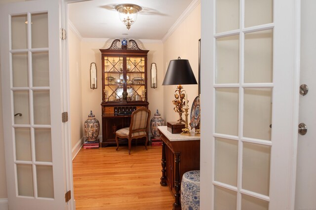 interior space featuring ornamental molding and light hardwood / wood-style flooring