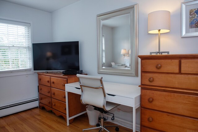 office space featuring a baseboard radiator and light wood-type flooring