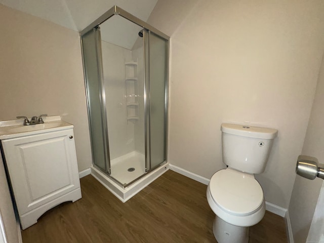 bathroom featuring walk in shower, vanity, toilet, and hardwood / wood-style flooring