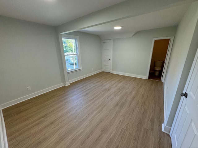 unfurnished bedroom featuring light hardwood / wood-style flooring and ensuite bathroom