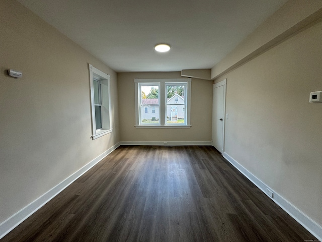 spare room featuring dark hardwood / wood-style floors