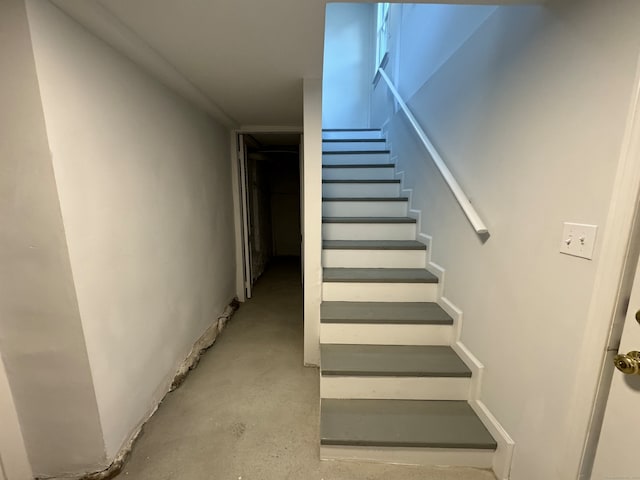 staircase with concrete floors