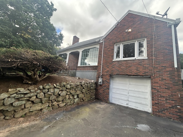 1920 Hartford Tpke, North Haven, CT 06473 - view of property exterior featuring brick siding, driveway, a chimney, and an attached garage