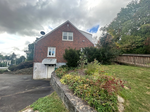 view of side of home featuring a lawn