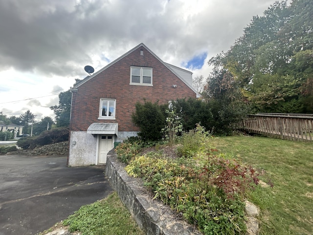 1920 Hartford Tpke, North Haven, CT 06473 - view of side of property featuring a lawn, driveway, fence, and brick siding