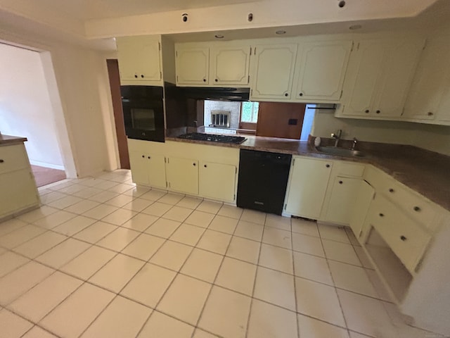 kitchen featuring black appliances, sink, and light tile patterned floors