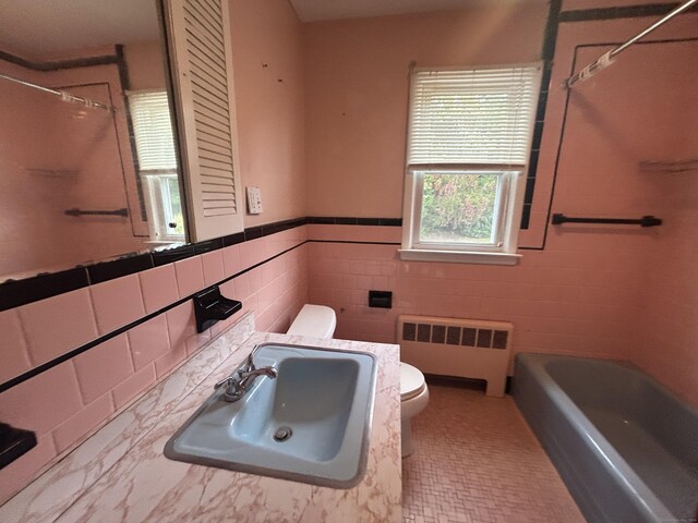 1920 Hartford Tpke, North Haven, CT 06473 - bathroom with a sink, toilet, tile walls, wainscoting, and radiator heating unit