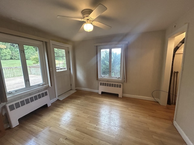 1920 Hartford Tpke, North Haven, CT 06473 - interior space featuring radiator heating unit, light wood-style flooring, baseboards, and a ceiling fan