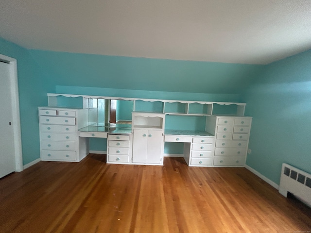 unfurnished bedroom featuring light wood-type flooring and radiator