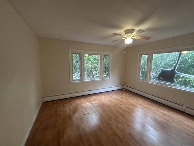 1920 Hartford Tpke, North Haven, CT 06473 - spare room with baseboard heating, wood finished floors, a ceiling fan, and a wealth of natural light
