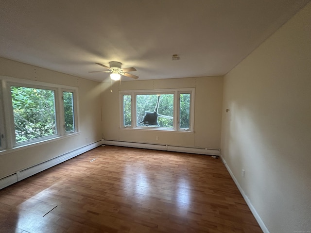 1920 Hartford Tpke, North Haven, CT 06473 - unfurnished room featuring wood finished floors, a baseboard heating unit, baseboards, and a ceiling fan