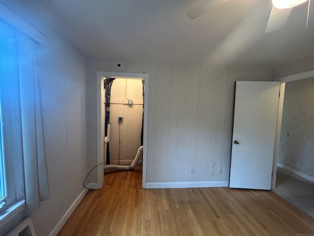 empty room featuring ceiling fan and light hardwood / wood-style floors