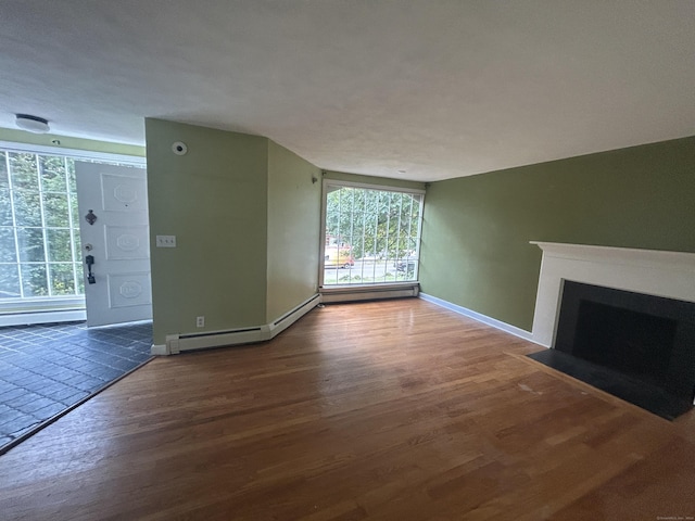 1920 Hartford Tpke, North Haven, CT 06473 - unfurnished living room featuring baseboards, a baseboard heating unit, wood finished floors, and a fireplace with flush hearth