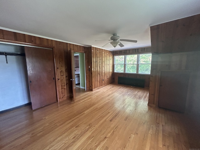 1920 Hartford Tpke, North Haven, CT 06473 - unfurnished bedroom featuring a ceiling fan, light wood-style floors, wooden walls, and ornamental molding